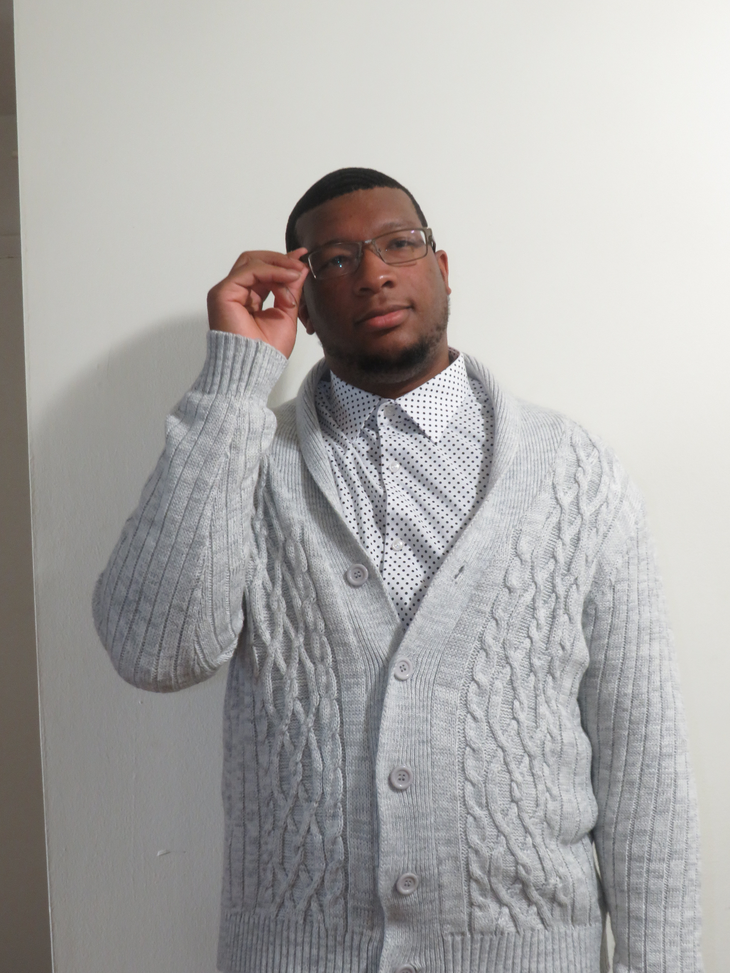 Valden Campbell wearing a knit cardigan.