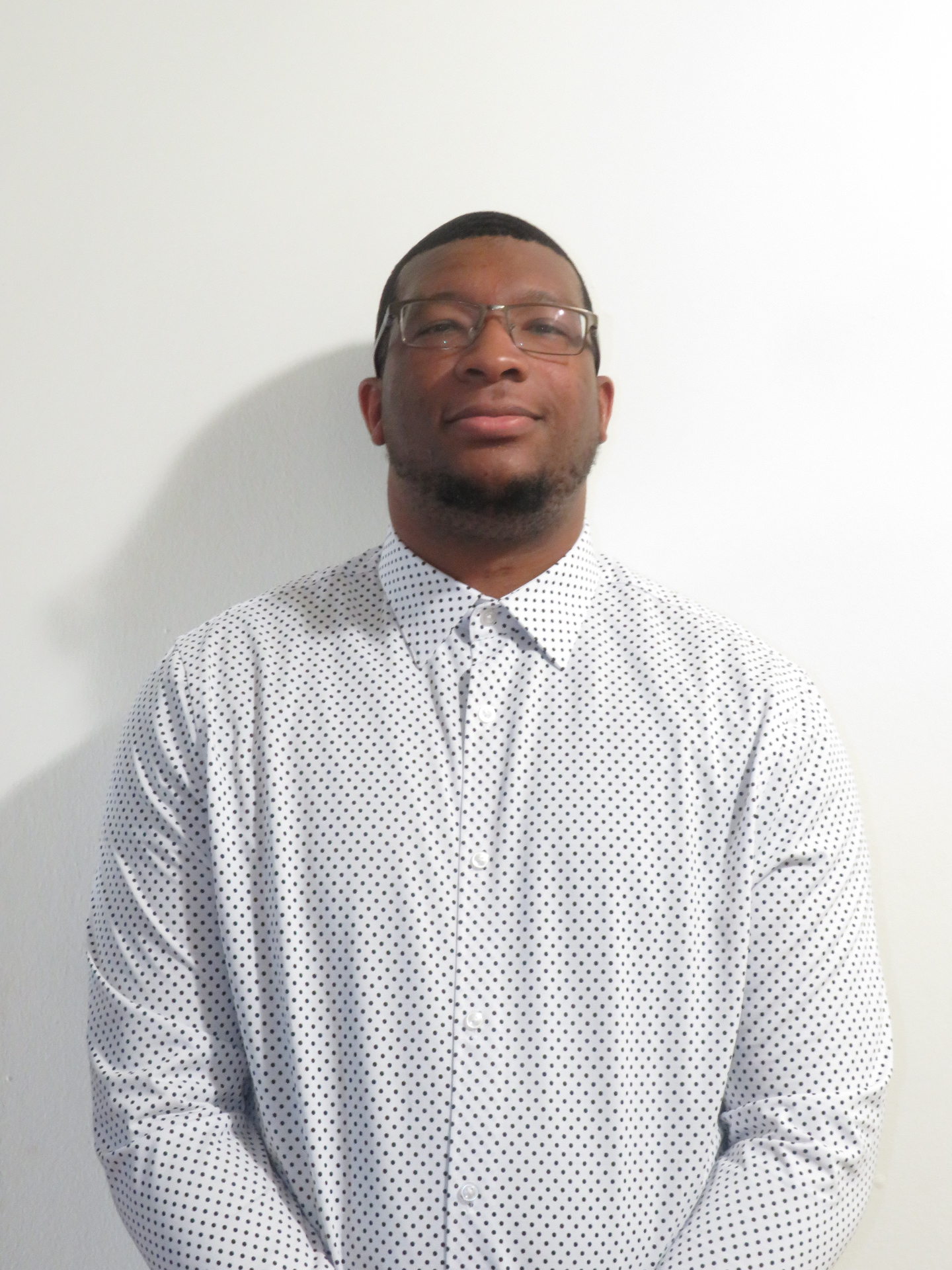 Valden Campbell in a white patterned shirt.
